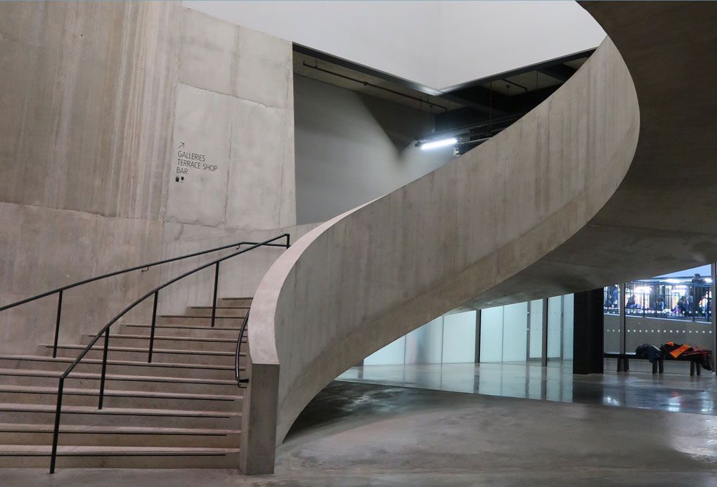 Concrete space featuring staircase with pre-primed metal rails