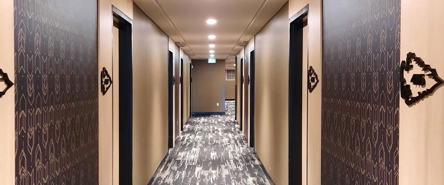 Dakota Dunes Hotel Hallway featuring a patterned wall paper