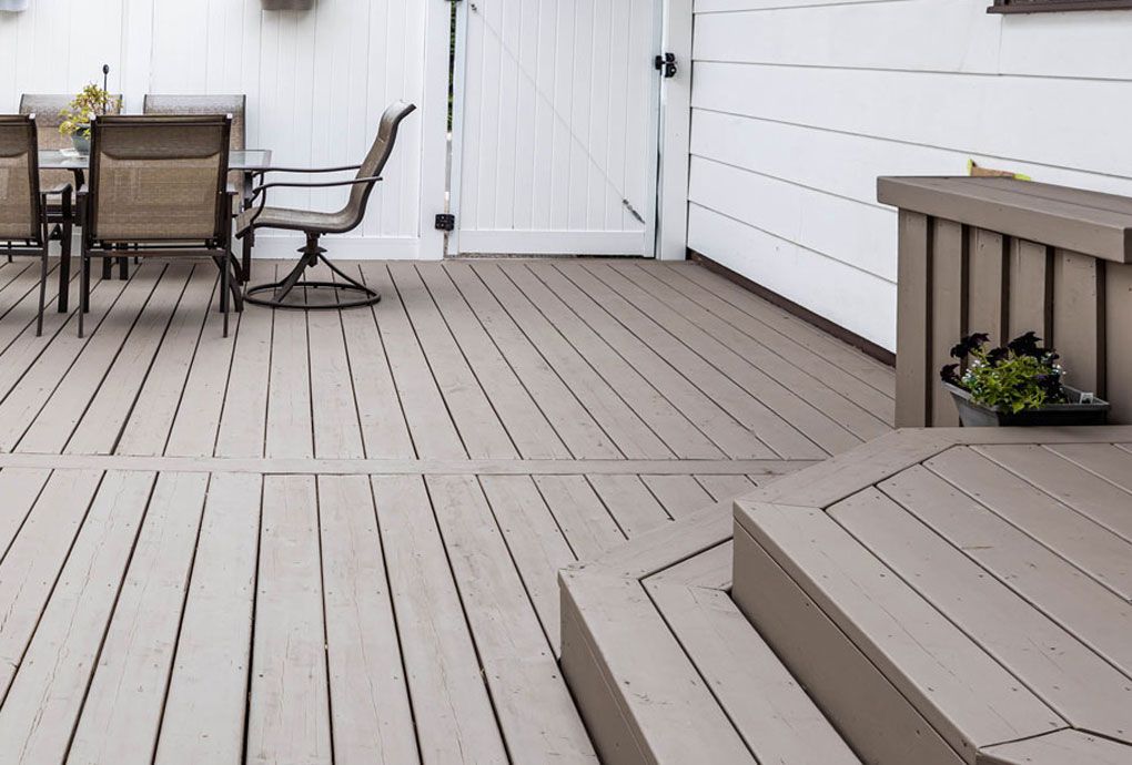 Newly painted cedar deck with a pristine white fence and trim.