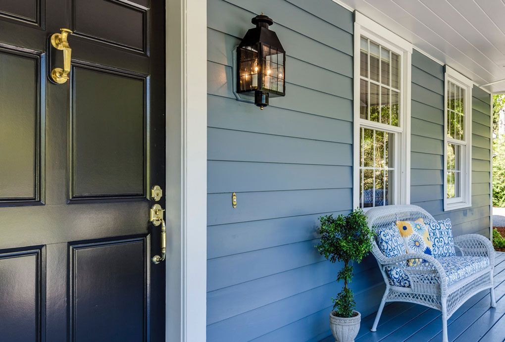 Image of a home with beautifully painted blue wood siding.