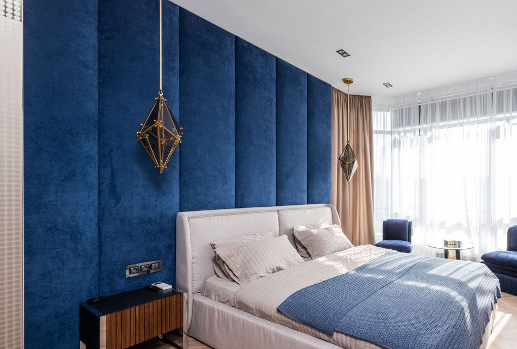 Velvet-textured fabric wall showcased behind a bedframe