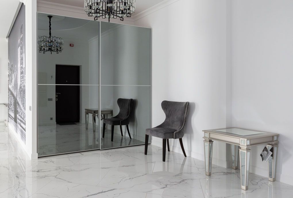 Mirror wall covering in marble detailed condo space.
