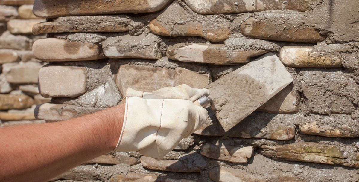 Worker Holding Trowel Tool — Apollo, PA — T. D. Brick Pointing, LLC