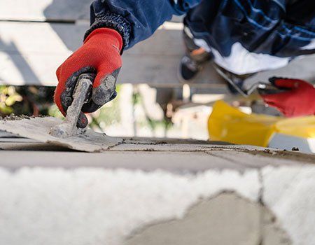 Worker Plastering a Wall with Trowel — Apollo, PA — T. D. Brick Pointing, LLC