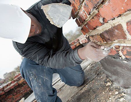 Man Using Trowel to Add Mortar — Apollo, PA — T. D. Brick Pointing, LLC