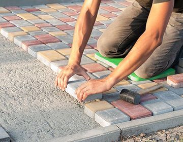 Worker Installing Colorful Bricks — Apollo, PA — T. D. Brick Pointing, LLC