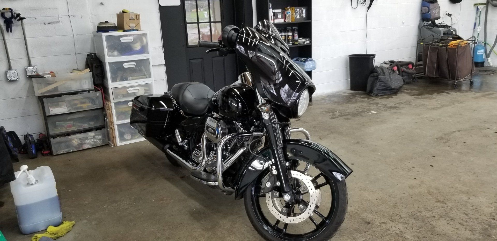 Black motorcycle parked inside a garage.