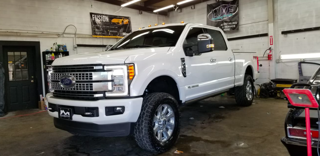 White Ford pickup truck in a garage.