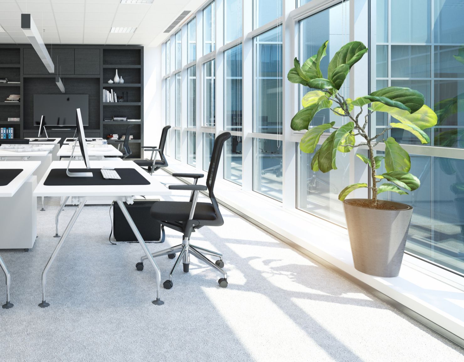 Modern office with white desks, black chairs, and computers Modern office with white desks, black chairs, and computers