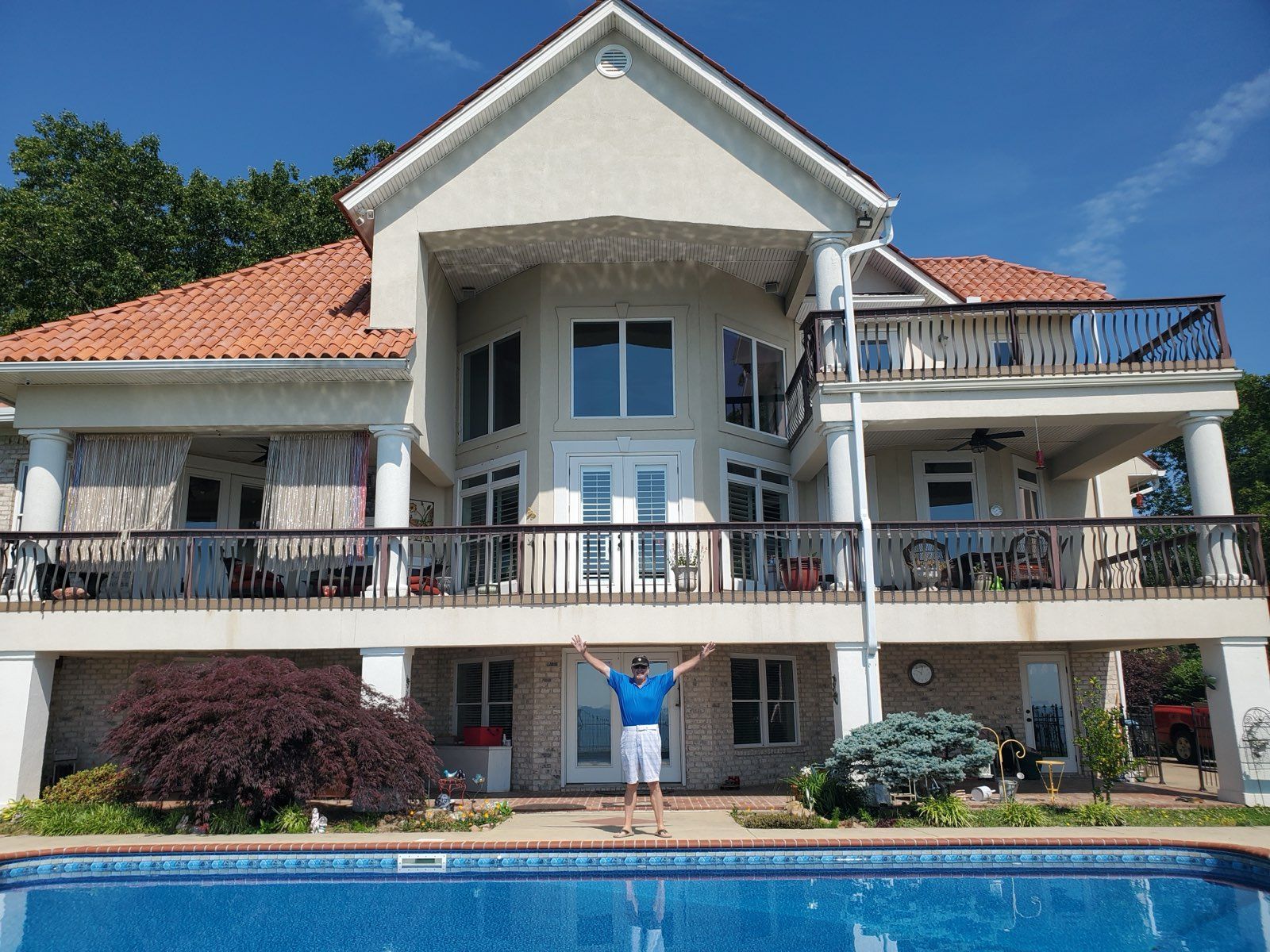 A group of men are standing on the roof of a house