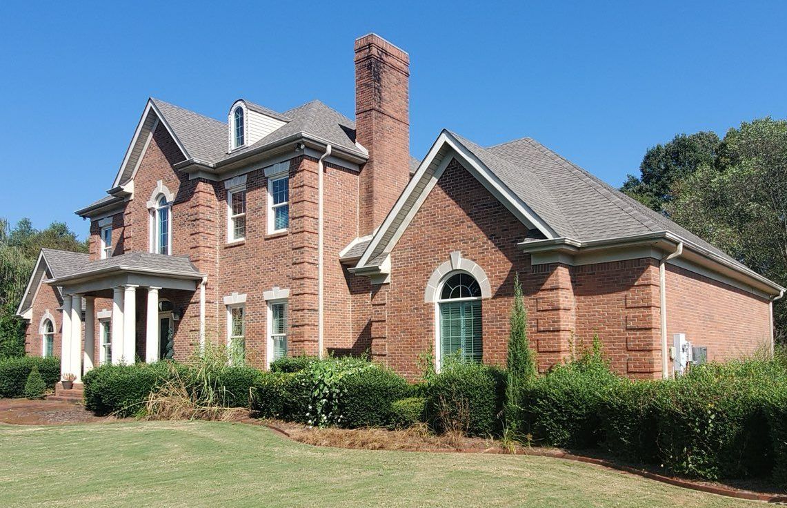 An aerial view of a house with a new roof being installed.