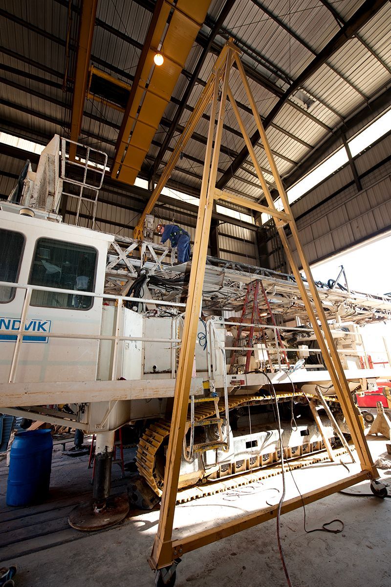 A large crane is sitting inside of a building.