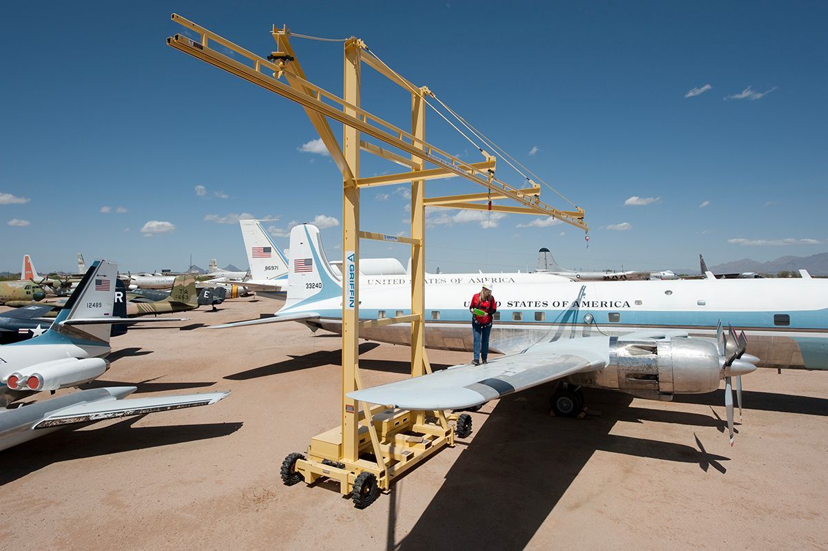 A man stands on the wing of an airplane