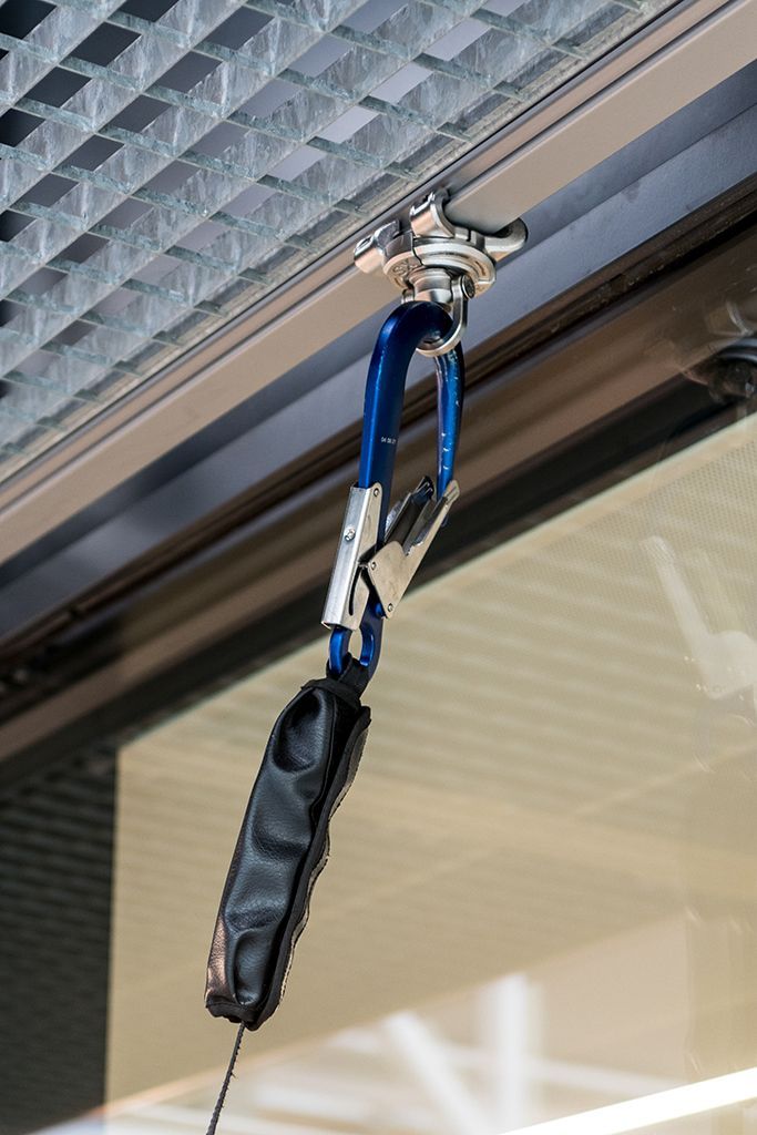A rope is hanging from the ceiling of a building.