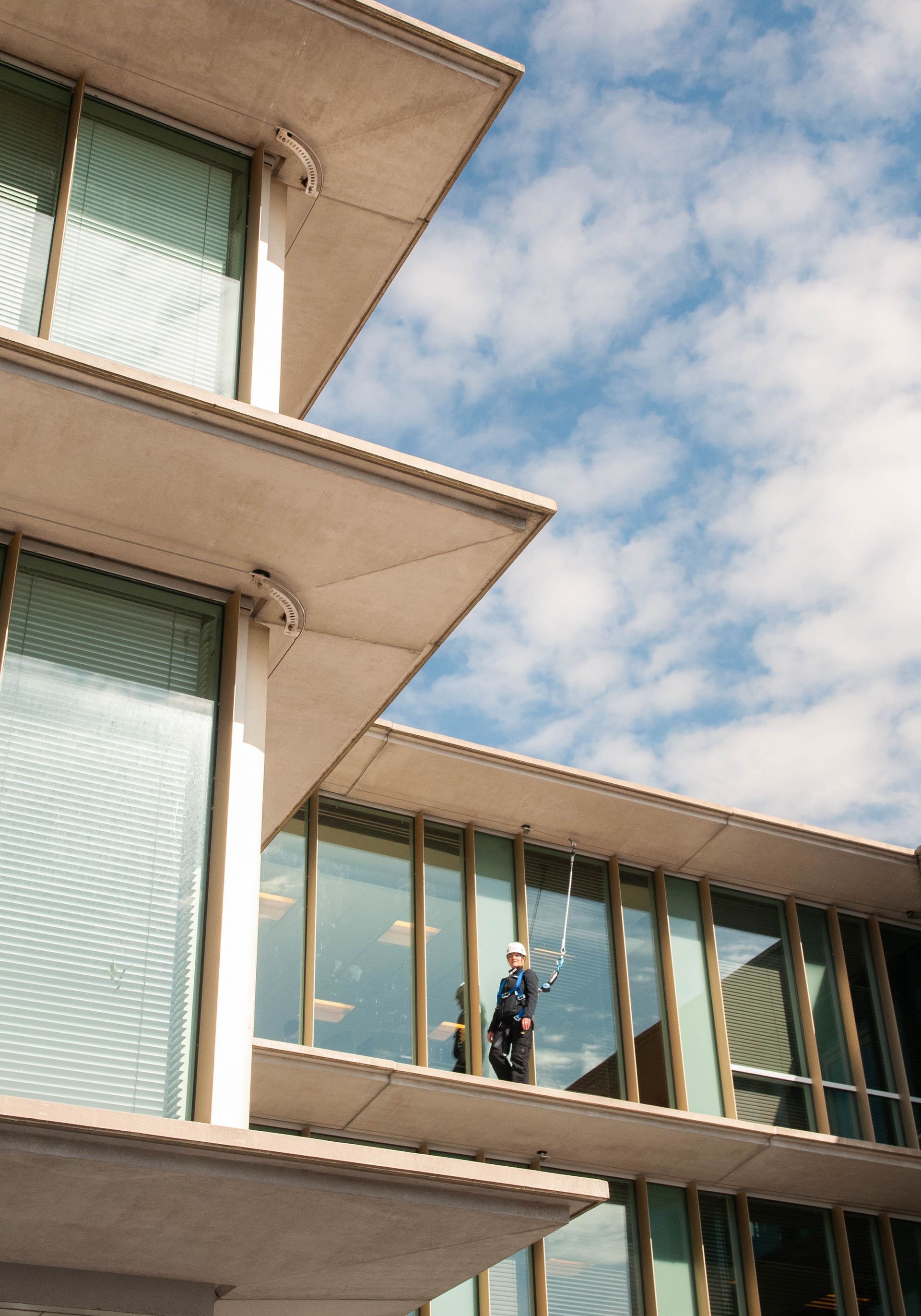 A man is standing on the balcony of a building