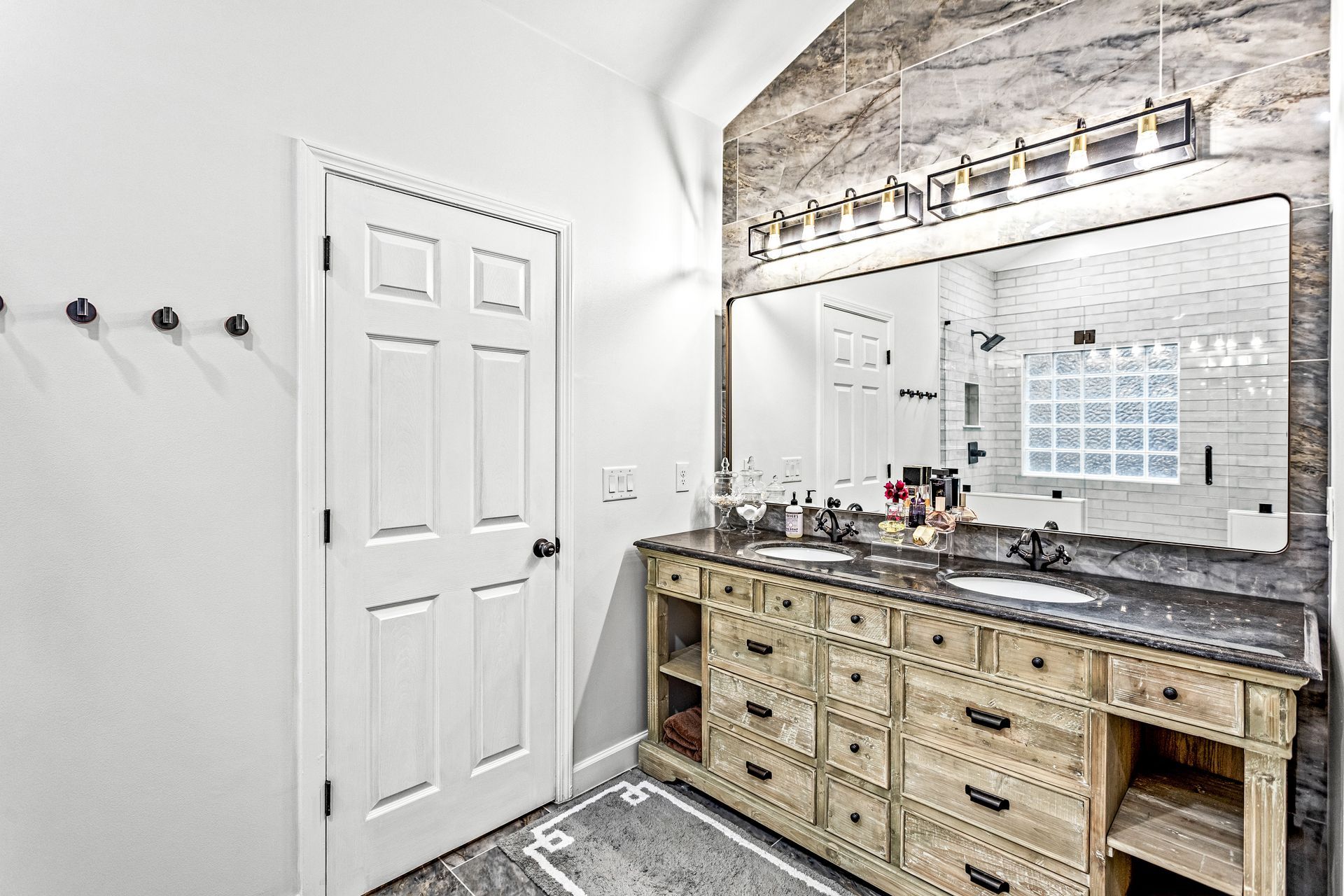 A bathroom with two sinks and a large mirror.