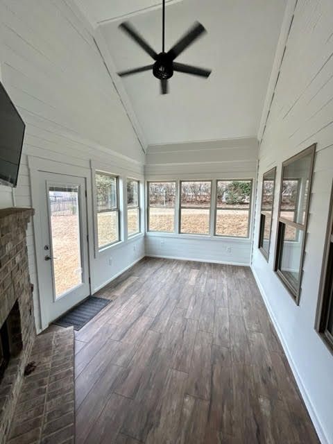 A living room with hardwood floors and a ceiling fan