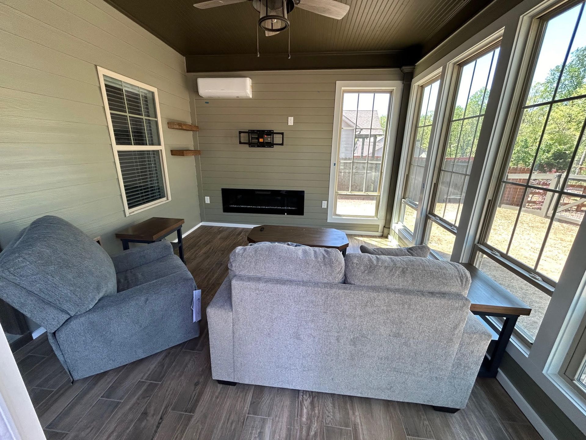 A living room with a couch , chair and fireplace.