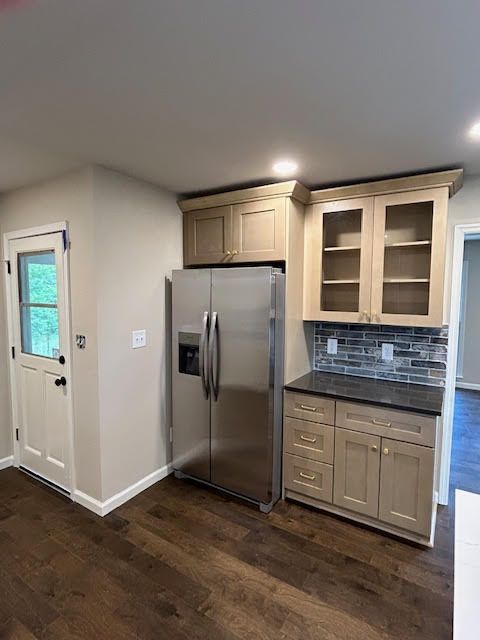 A kitchen with stainless steel appliances and wooden cabinets.