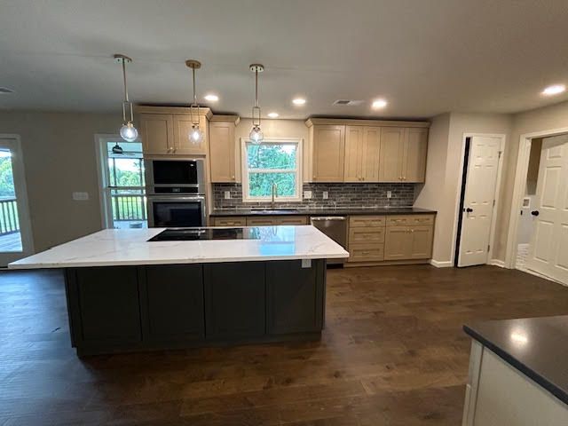 A kitchen with a large island in the middle