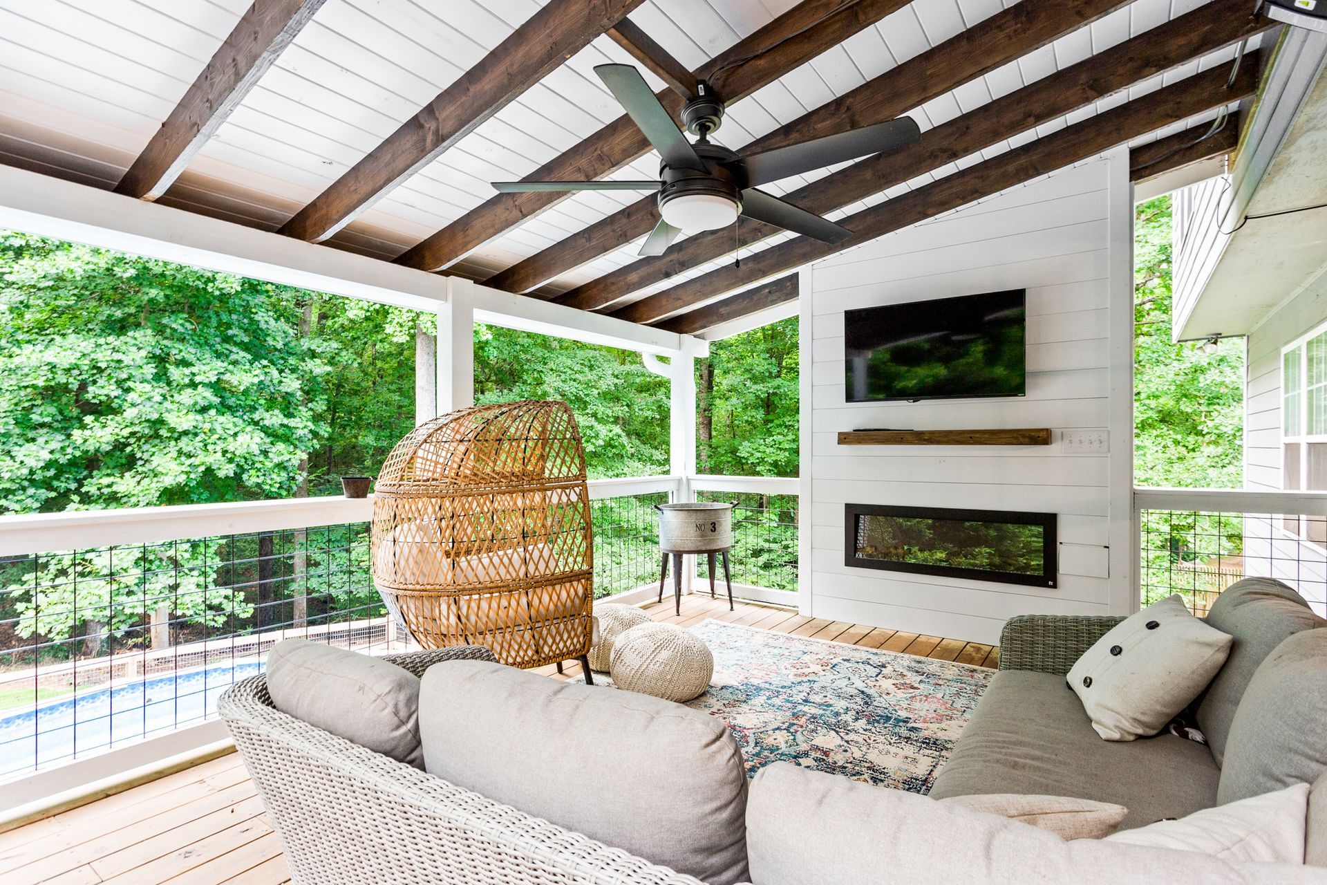 A screened in porch with stairs leading up to it