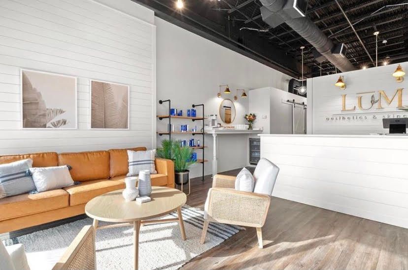 A living room with a couch , chair , table and counter.