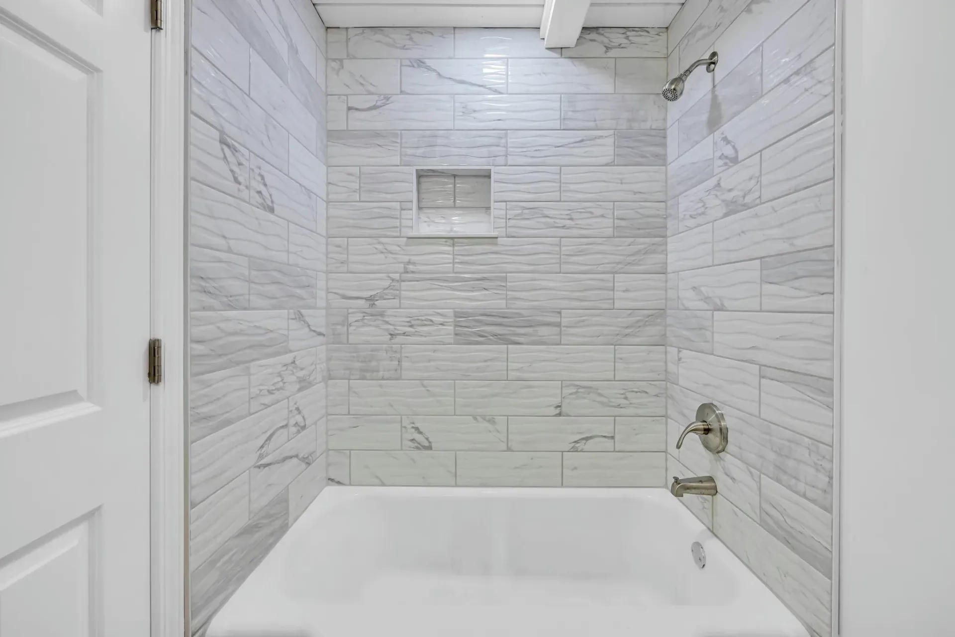 A bathroom with a bathtub and a shower.