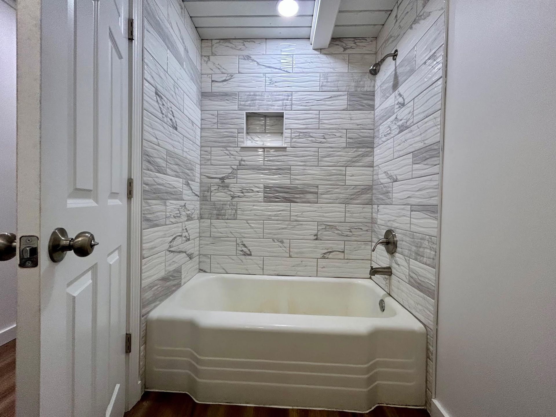 A bathroom with a bathtub and a shower.