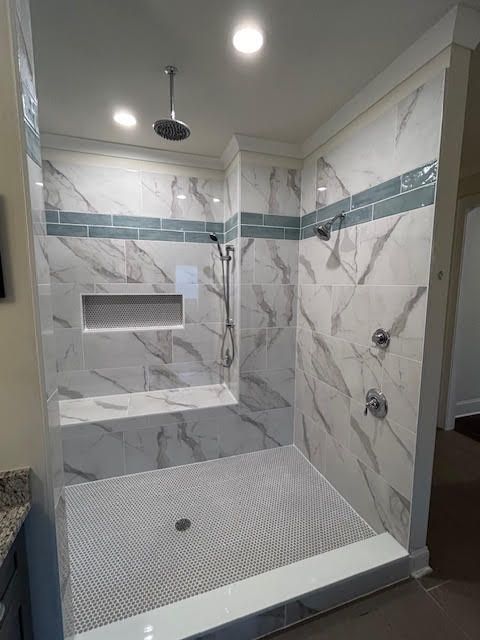 A bathroom with a walk in shower and a bathtub.