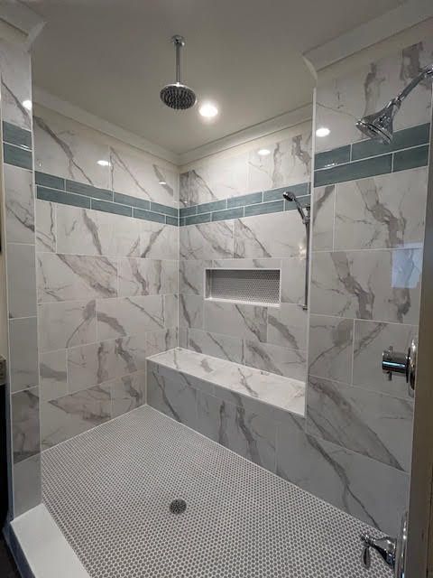 A bathroom with a walk in shower and a bathtub.