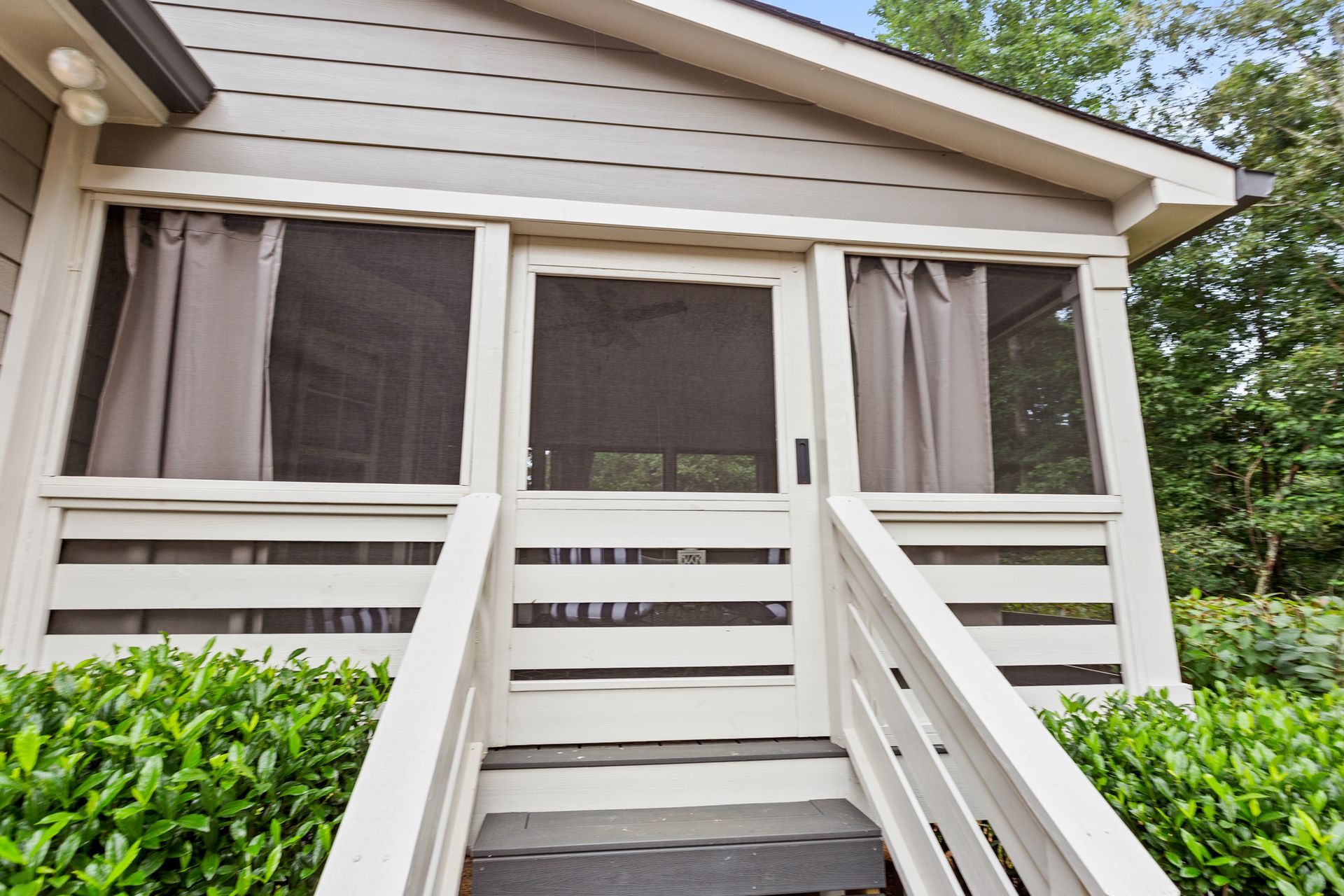 A screened in porch with stairs leading up to it
