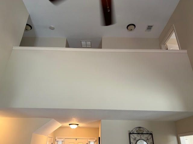 A ceiling fan is hanging from the ceiling of a room.