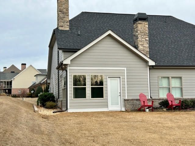 A house with two red chairs in front of it
