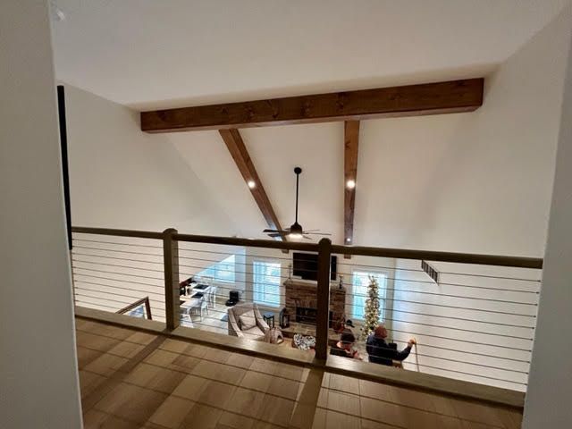 A view of a living room from a balcony with a ceiling fan