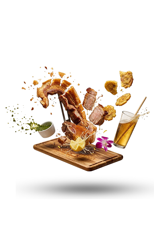Crispy fried food splashing onto a wooden board, with fries and a drink on a white background