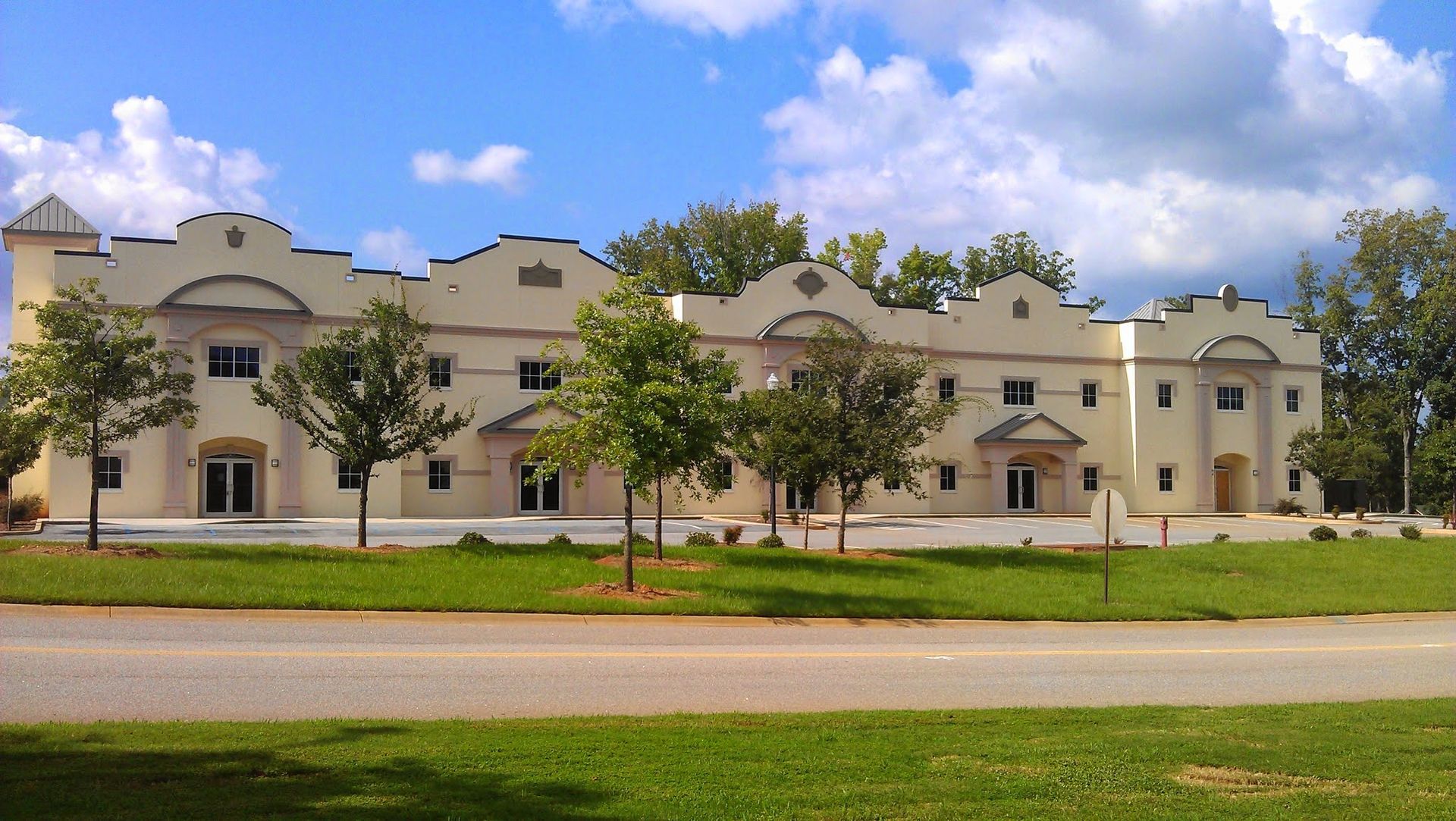 A large white building with trees in front of it