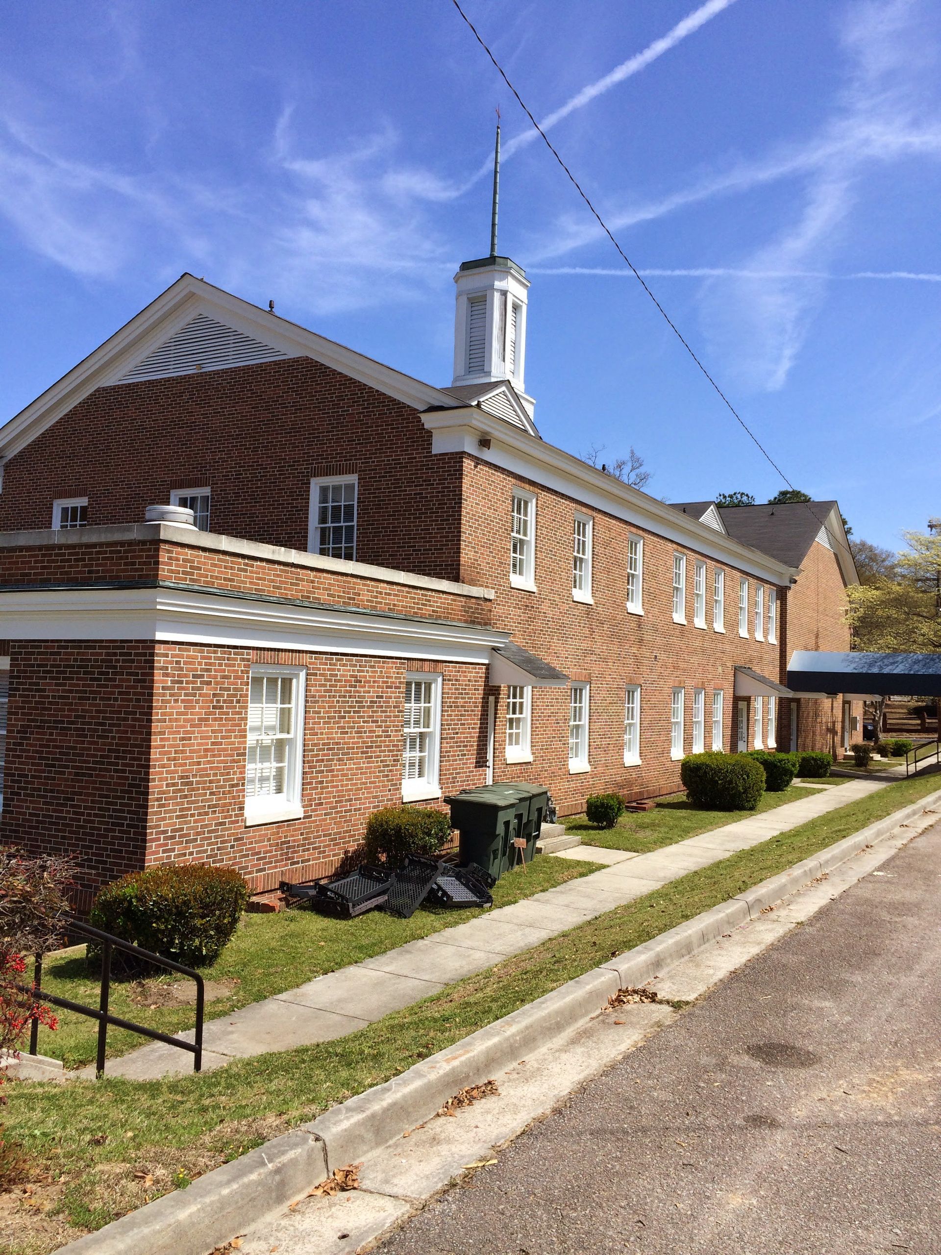 A large brick building with a clock tower on top of it.