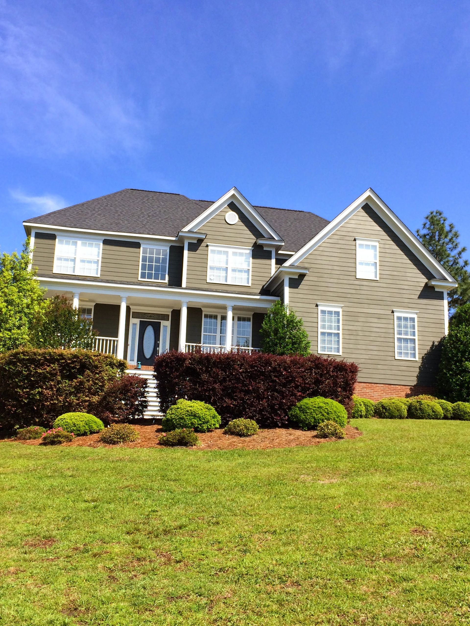 A large house with a large lawn in front of it