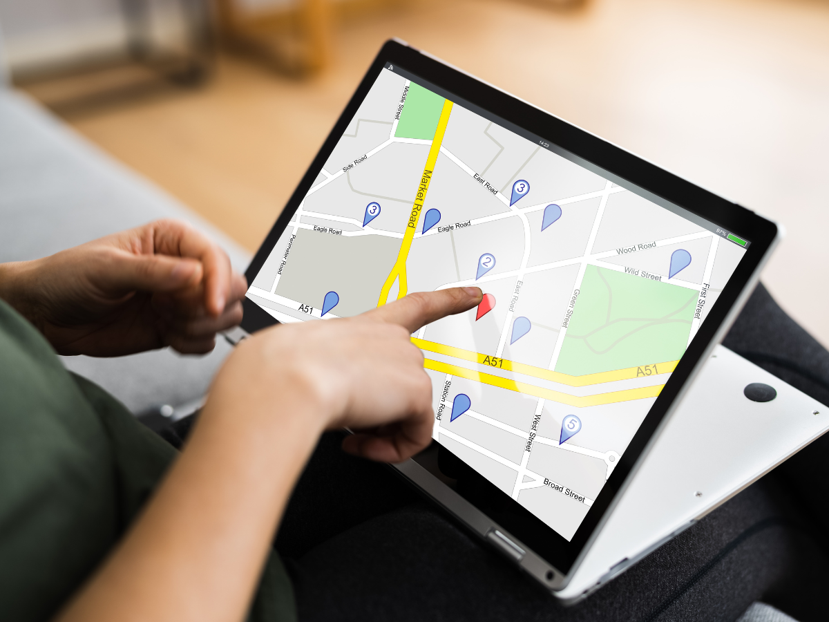 A person is pointing at a map on a tablet computer. A person is pointing at a map on a tablet computer.
