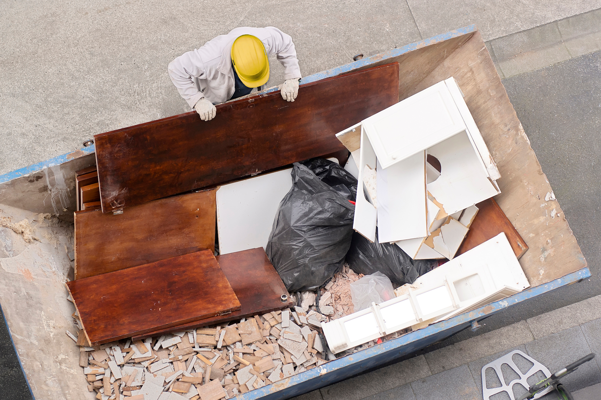 Man Adding Item to Dumpster for a Junk Removal Job
