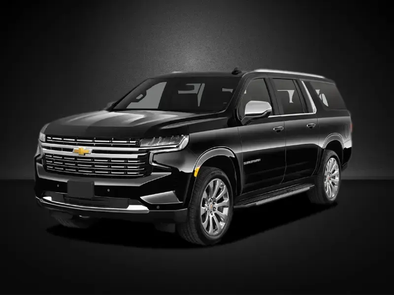 A black chevrolet suburban suv is parked on a black background.