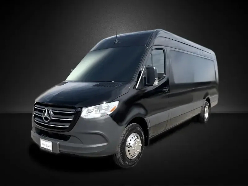 A black mercedes sprinter van is parked on a black background.