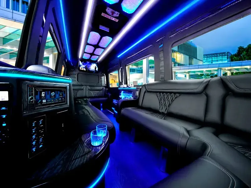 The inside of a limousine with blue lights on the ceiling.