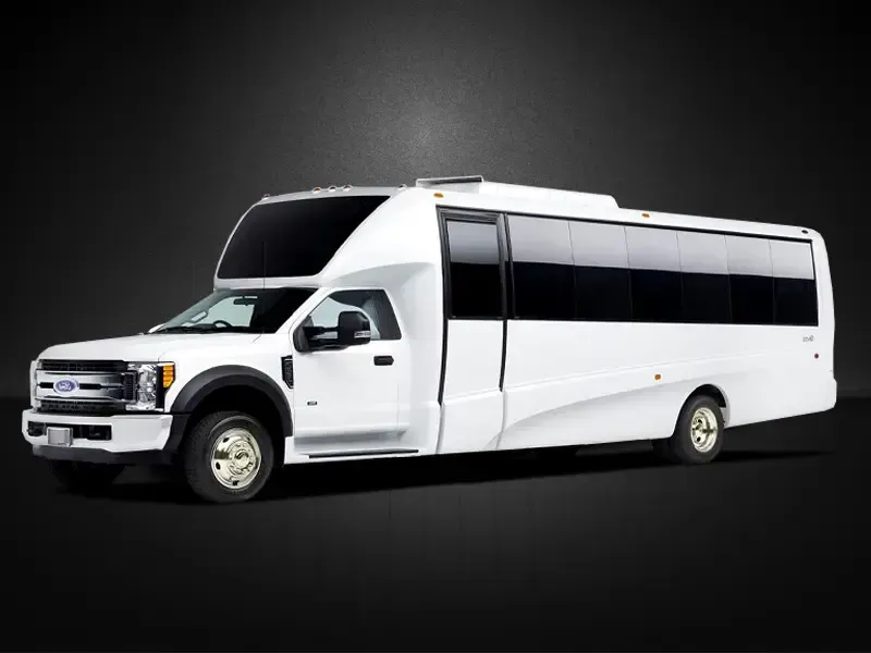 A white bus is parked on a black background.