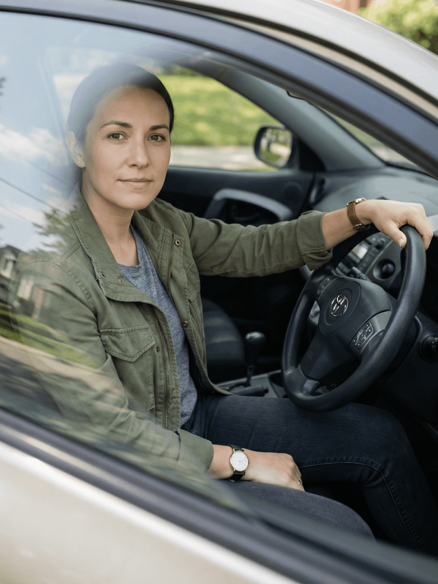 Woman with dark curly hair looks lovingly at a man in white shirt, outdoors.