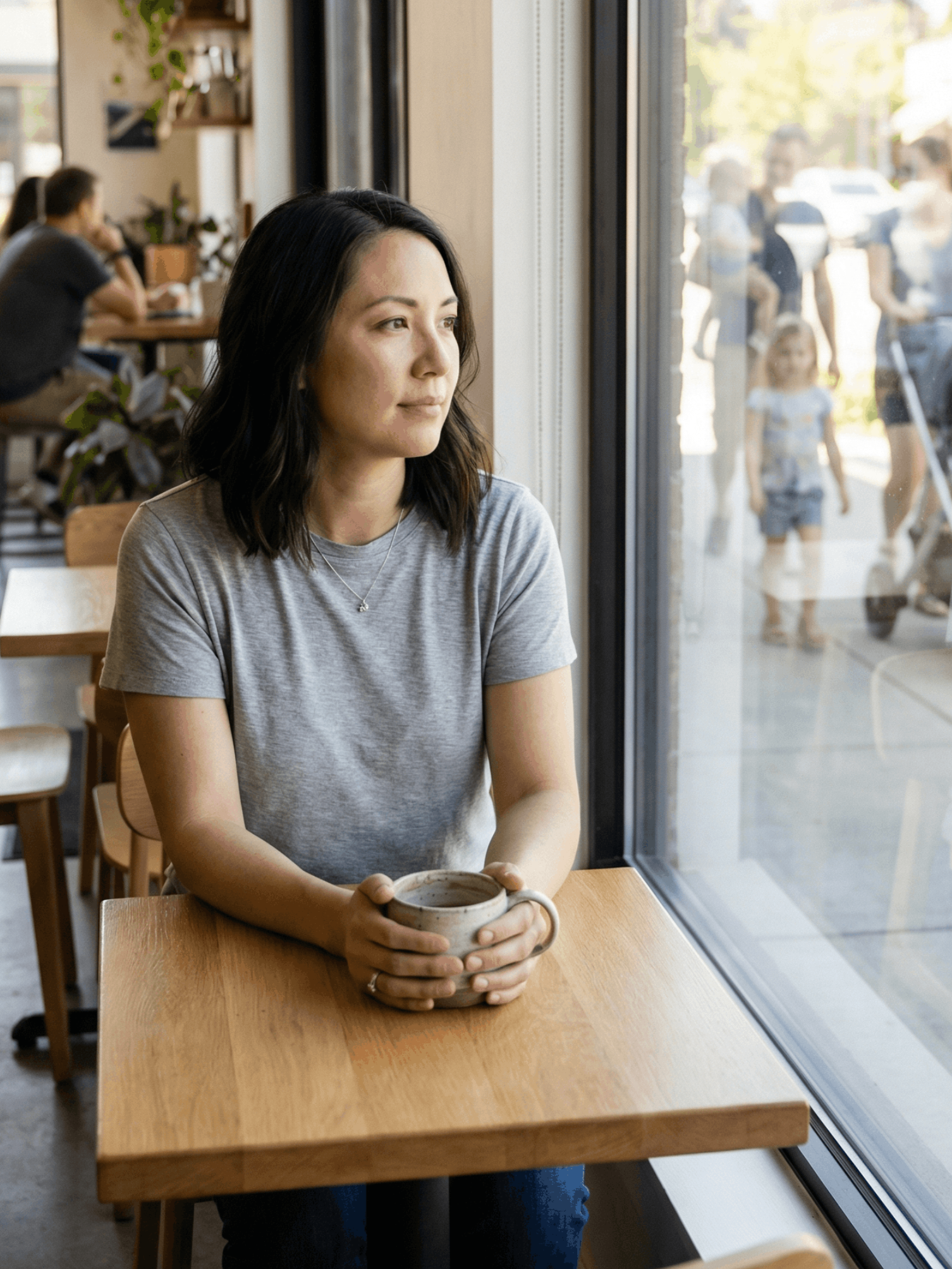 Woman with dark curly hair looks lovingly at a man in white shirt, outdoors.