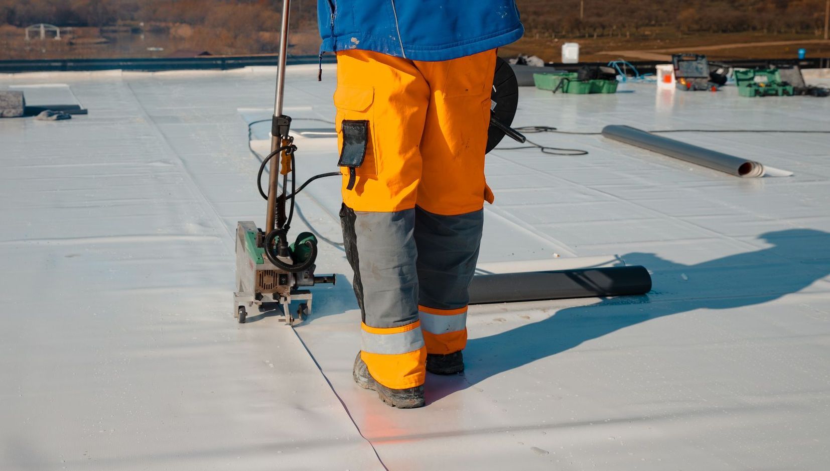 A group of construction workers are installing solar panels on a roof.