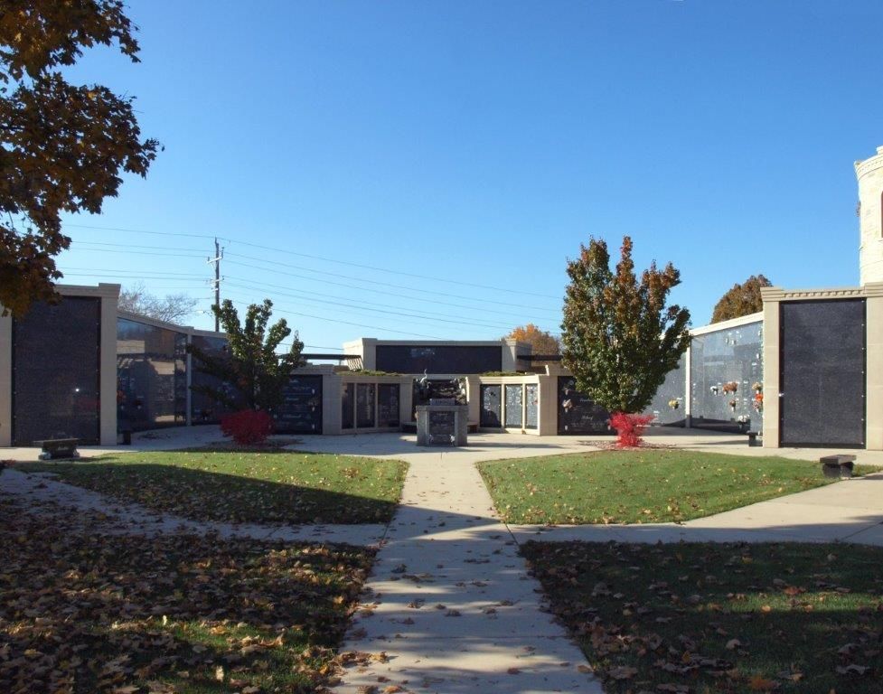 A walkway leading to a building with a blue sky in the background
