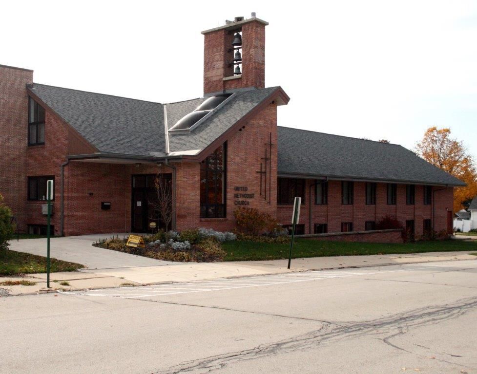 A large brick building with a steeple on top of it