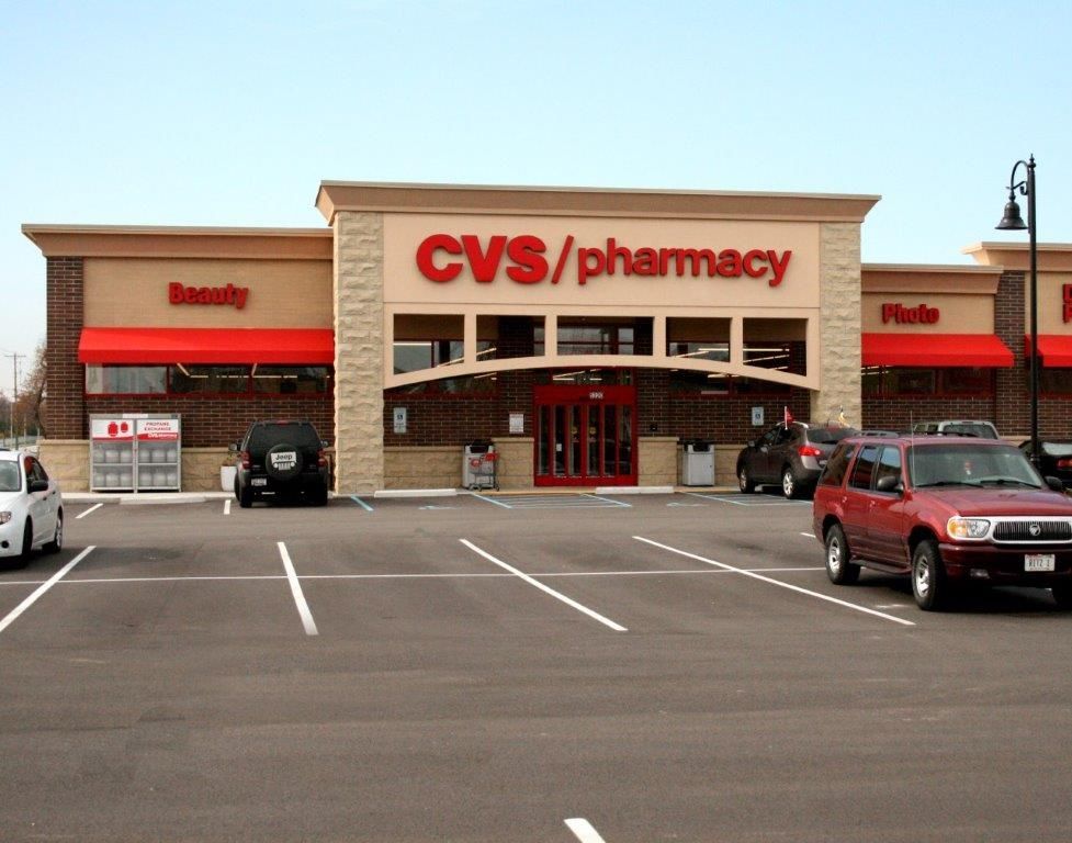 Cars are parked in front of a cvs pharmacy